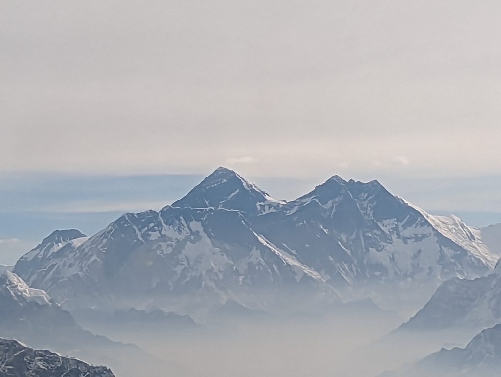 Picture of women wearing Shetla Sun hat in Nepal. Water Buffalo and mountains in background